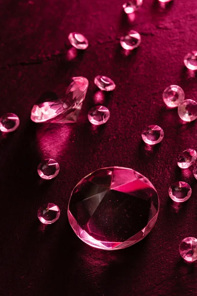 Different diamonds with red light — Stock Photo, Image
