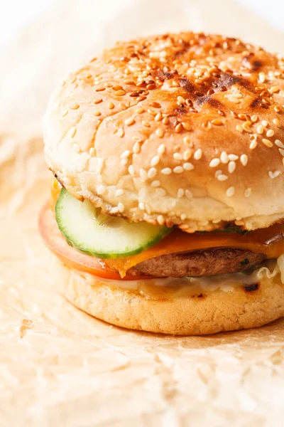 Tasty burger on paper — Stock Photo, Image