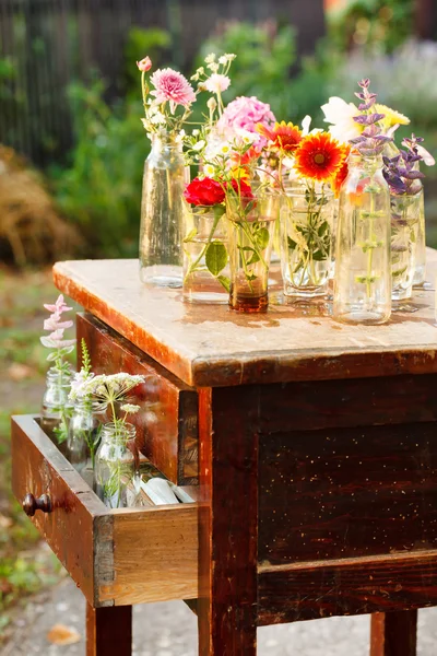 Nice flowers in bottles — Stock Photo, Image