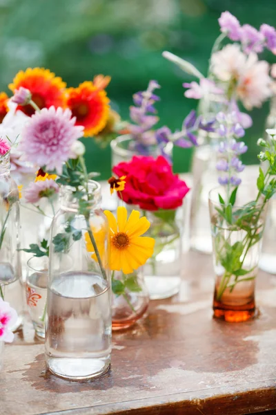 Nice flowers in bottles — Stock Photo, Image