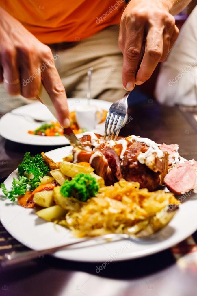 Man eating pork — Stock Photo © Shebeko 68178241