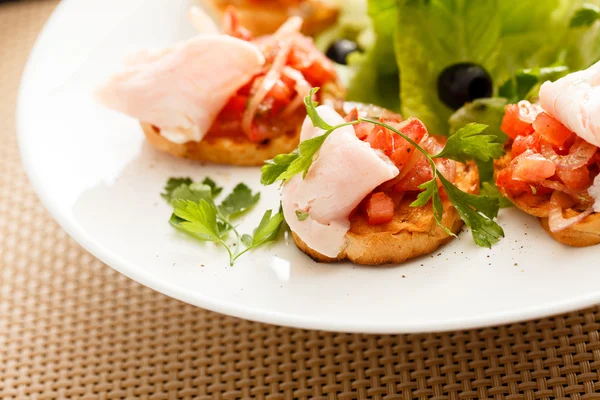 Bruschettas com tomate e presunto — Fotografia de Stock