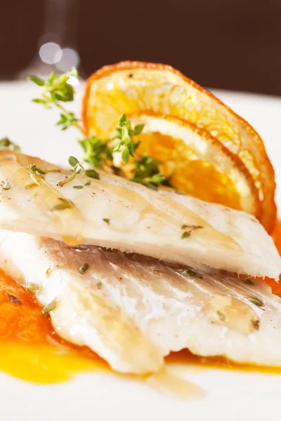 Fish with orange slices — Stock Photo, Image