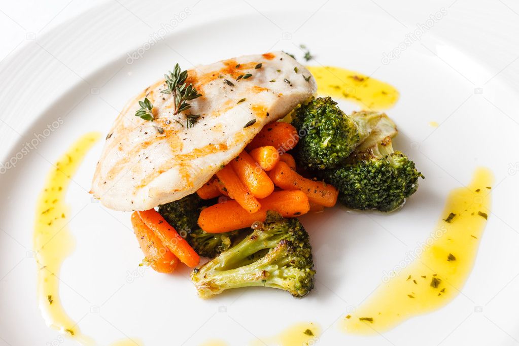 Fish with vegetables on plate