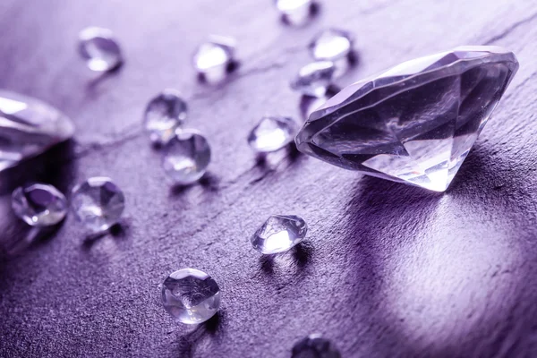 Different diamonds with purple light — Stock Photo, Image