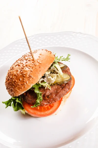 Tasty burger with tomatoes — Stock Photo, Image