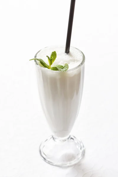 Milk cocktail in glass with straw — Stock Photo, Image