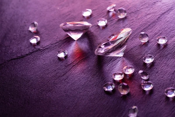 Different diamonds with purple light — Stock Photo, Image