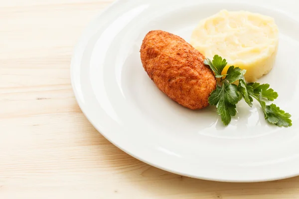 Chicken cutlet with potato on plate — Stock Photo, Image