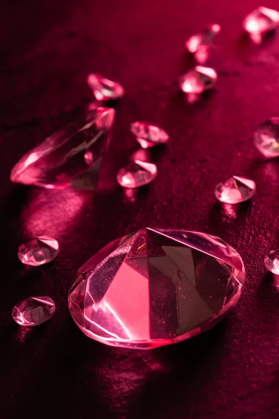 Different diamonds with red light — Stock Photo, Image