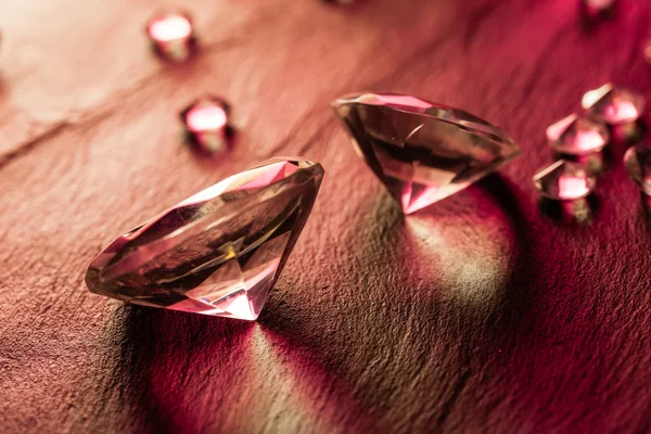 Different diamonds with red light — Stock Photo, Image