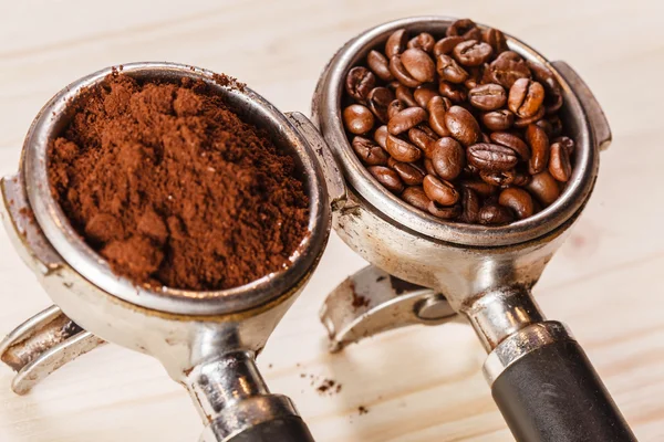 Grounded coffee and beans in handle — Stock Photo, Image