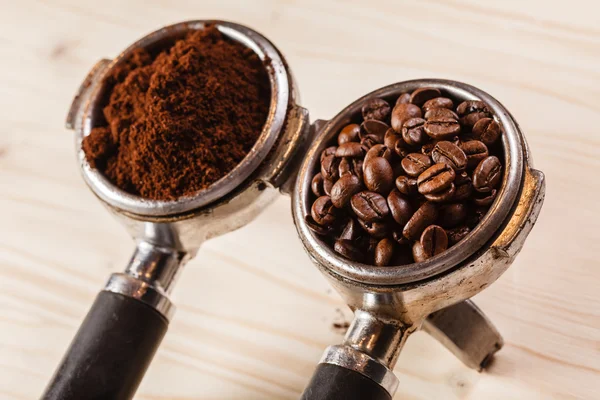 Grounded coffee and beans in handle — Stock Photo, Image