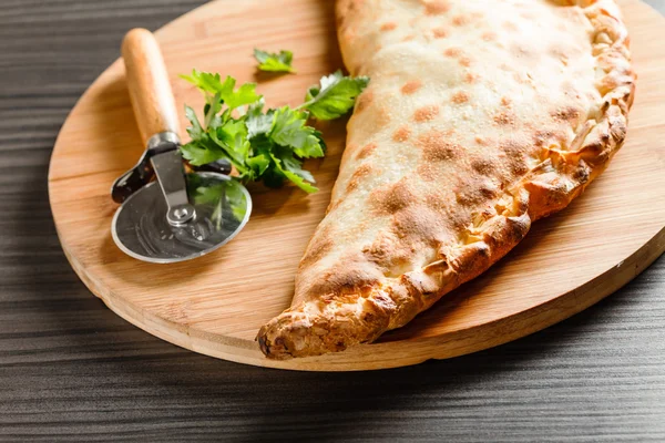 Calzone pizza with parsley — Stock Photo, Image