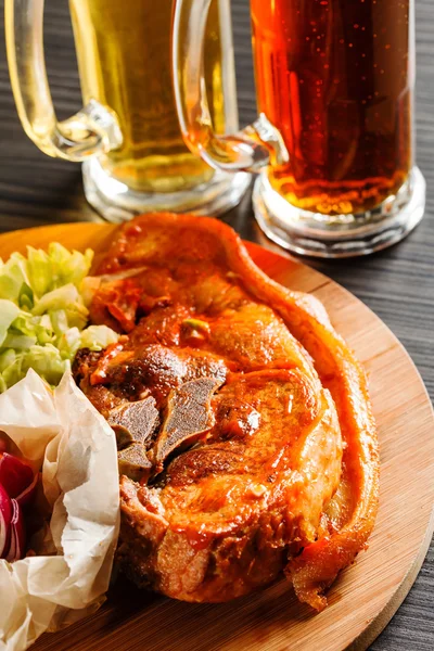 Meat with salad on wooden board — Stock Photo, Image