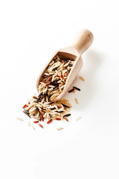 Brown rice in wooden spoon — Stock Photo, Image