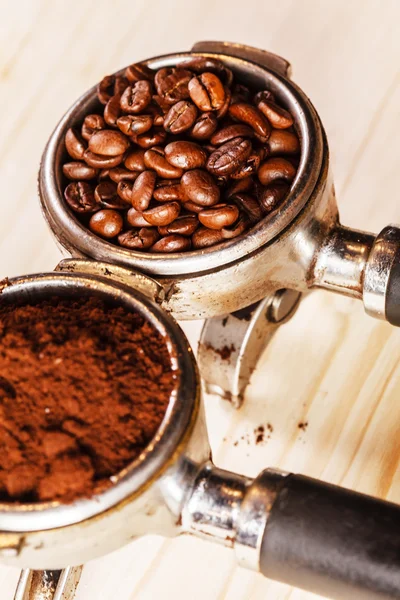 Coffee handle with ground coffee and beans — Stock Photo, Image