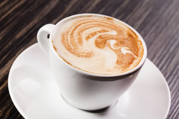 Cup of cappuccino on table — Stock Photo, Image