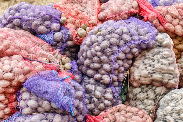 Potatoes in bags at farmers market — Stock Photo, Image