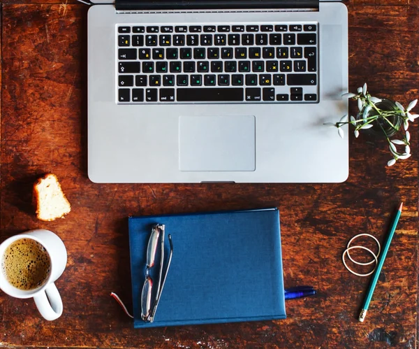 Laptop en leveringen op tafel — Stockfoto