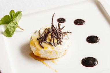 Cheesecake with chocolate and mint leaf