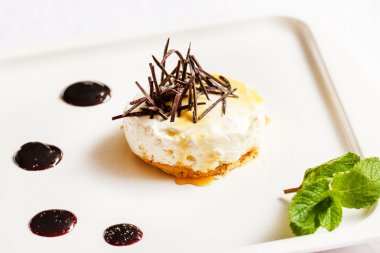 Cheesecake with chocolate and mint leaf