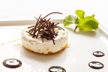 Cheesecake with chocolate and mint leaf