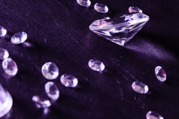 Different diamonds in purple light — Stock Photo, Image