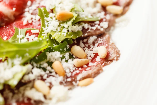 Meat carpaccio with rucola — Stock Photo, Image