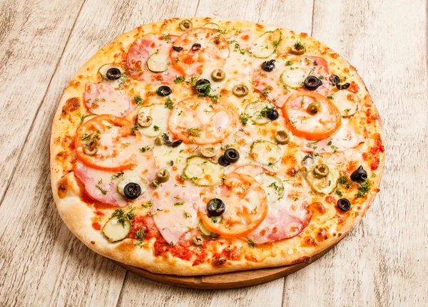 Pizza on wooden background — Stock Photo, Image