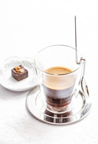 Espresso in glass with candy — Stock Photo, Image