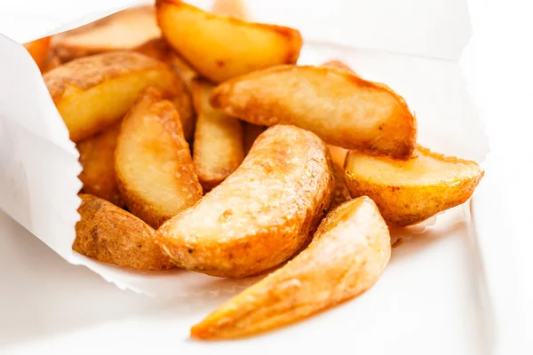 Roasted potatoes in paper bag — Stock Photo, Image