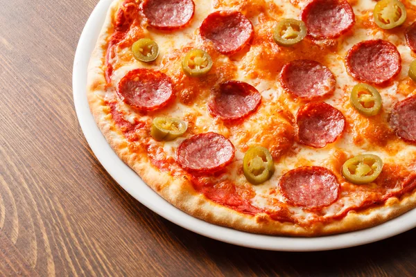 Pizza on wooden background — Stock Photo, Image