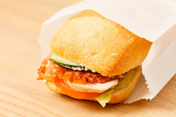 Tasty sandwich in paper bag — Stock Photo, Image