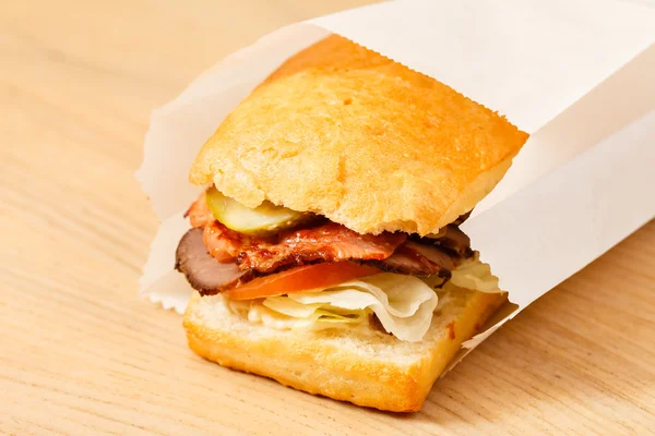 Tasty sandwich in paper bag — Stock Photo, Image