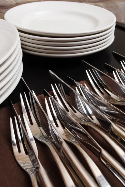 Forks and plates on table — Stock Photo, Image