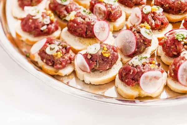 Tasty canapes with meat and radish — Stock Photo, Image