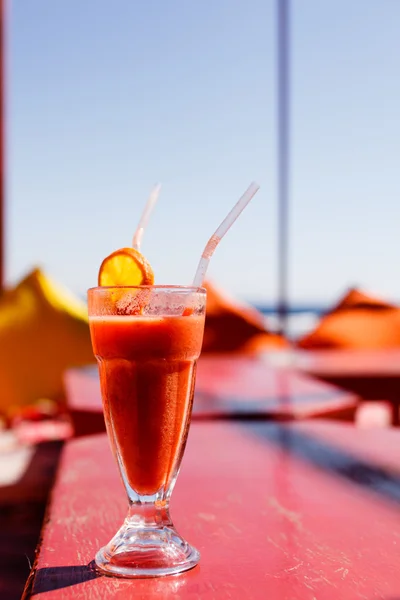 Glass of fruit smoothie with straws — Stock Photo, Image