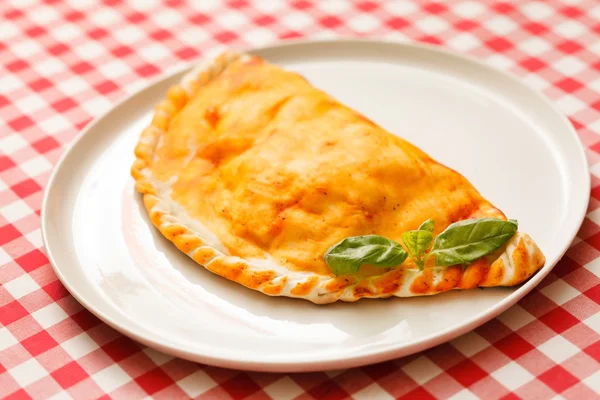 Calzone pizza on plate — Stock Photo, Image