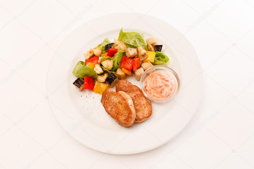 Cutlets with vegetables and sauce
