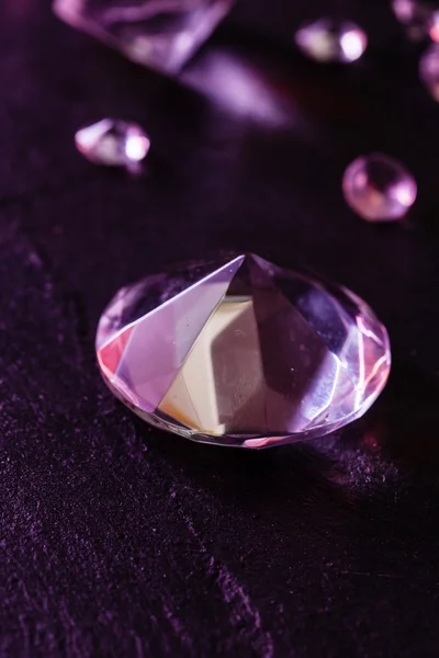 Different diamonds on purple background — Stock Photo, Image