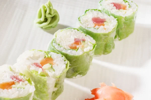 Tasty sushi rolls with cabbage — Stock Photo, Image