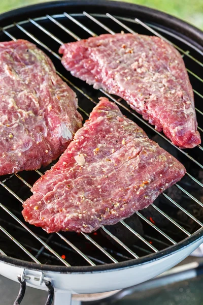 Preparing delicious steaks on grill — Stock Photo, Image