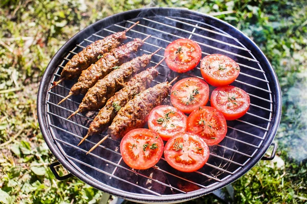 Grilling kebabs with tomatoes — Stock Photo, Image