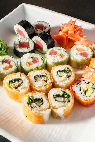 Tasty sushi rolls set on plate — Stock Photo, Image