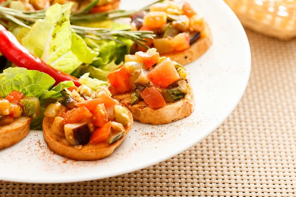 Tasty bruschettas with vegetables — Stock Photo, Image