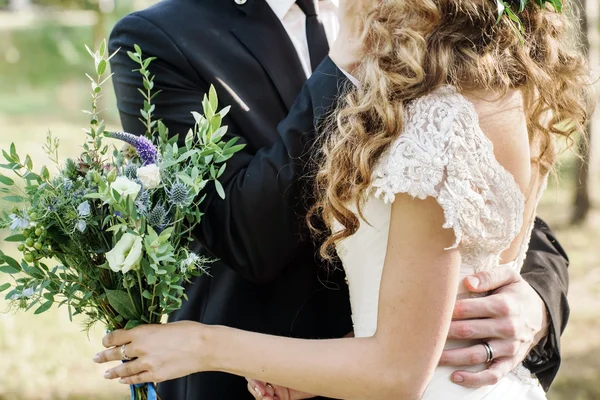 Novio y novia sosteniendo flores — Foto de Stock