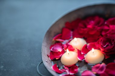 Kırmızı gül yaprakları ve mum