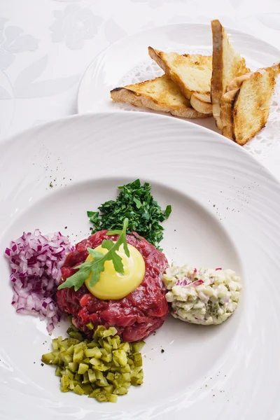Tartare with egg on plate — Stock Photo, Image