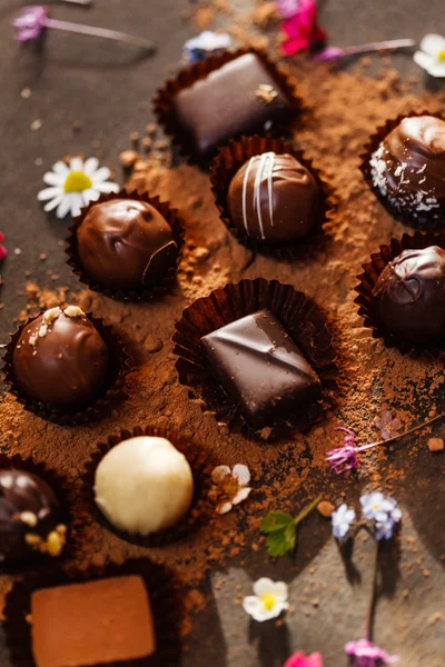 Chocolate sweets with flowers — Stock Photo, Image